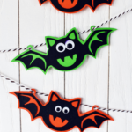 three paper bats with googly eyeson a bakers twine garland