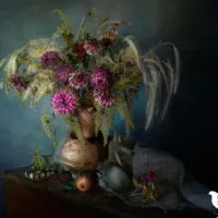 vase with dried flowers against a blue background