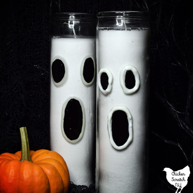 two ghost candles made from dollar tree prayer candles