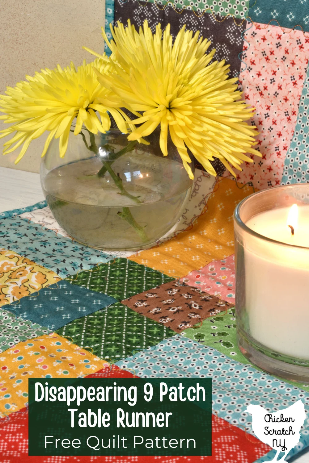 disappearing nine patch table runner made with Lori Holt Stitch fabric with a vase holding two yellow spider mums and a lit candle with text overlay "Disappearing 9 patch table runner free quilt pattern"