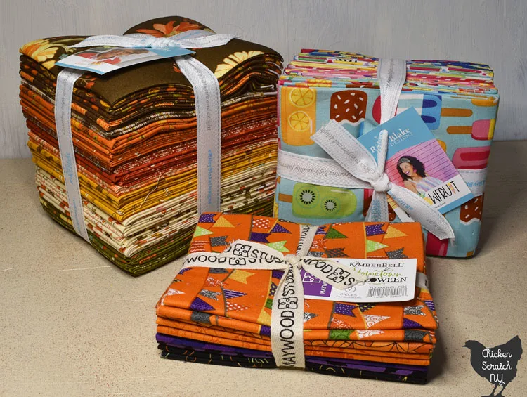three fat quarter bundles including a small Halloween bundle, a bright rainbow bundle and large bundle with autumn colors