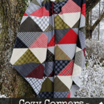 flannel half square triangle quilt hanging over a tree branch in a wintery forest with text overlay "Cozy corners Free layer cake quilt pattern"