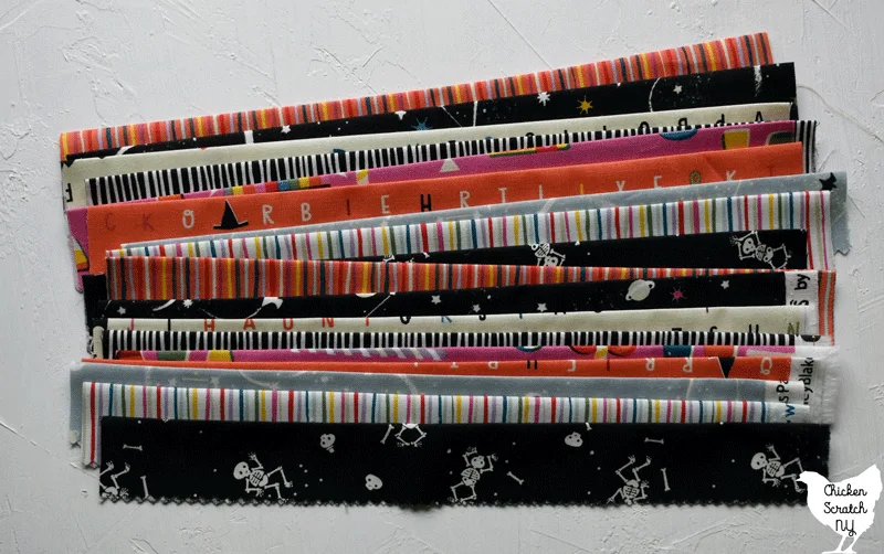 cut, pressed and stacked sections of Jelly Roll strips ready for scrappy binding