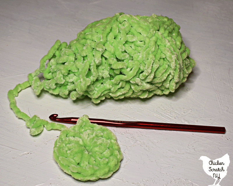 skein of lime just chenille yarn from dollar tree with small double crocheted circle showing stitch definition