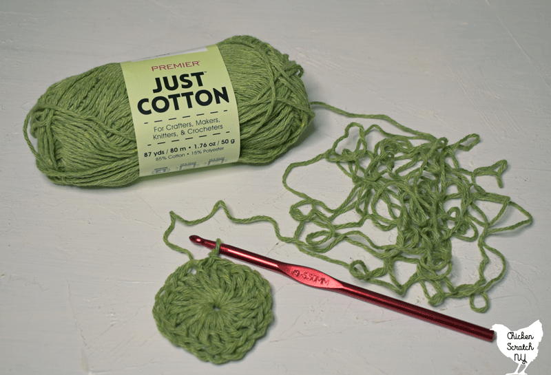 skein of sage green just cotton yarn from Dollar Tree with a small double crochet circle showing stitch definition