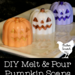 three pumpkin melt and pour soaps made in orange, white and purple with metallic faces
