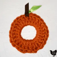 single pumpkin scrunchie made with Bernat Softee Chunks yarn