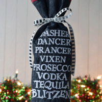 wine bag made with black fabric and red & black plaid with white snowflakes lining
