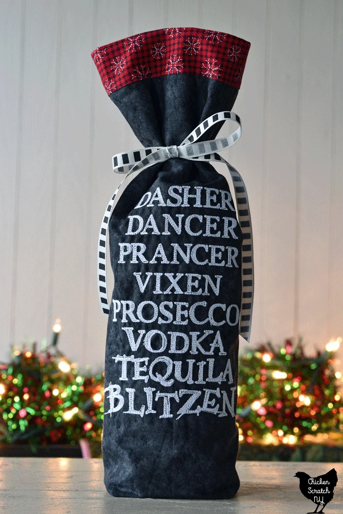 wine bag made with black fabric and red & black plaid with white snowflakes lining 