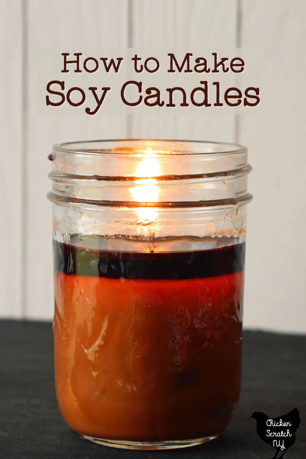 lit 8oz jelly jar candle with dark orange wax