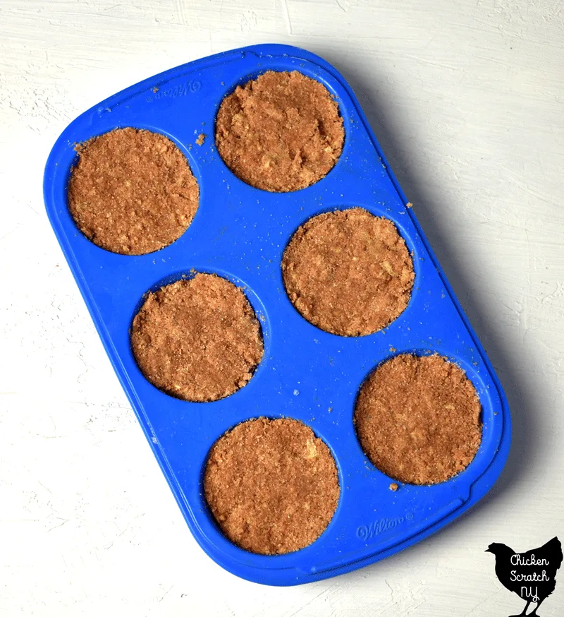 blue silicone muffin tin filled with pumpkin cheesecake sugar scrub bars