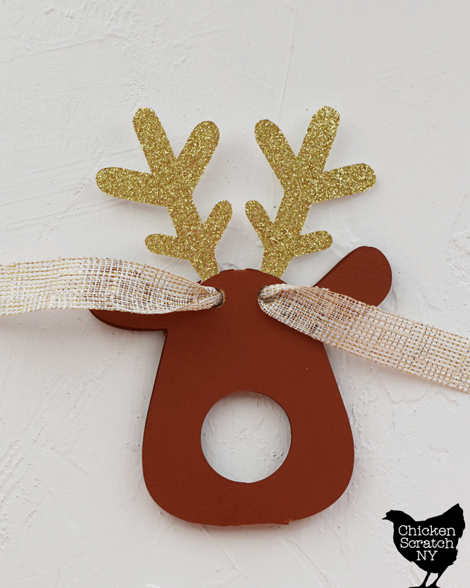 add the ribbon by running it thjrough all the holes to close up the reindeer truffle nose ornament