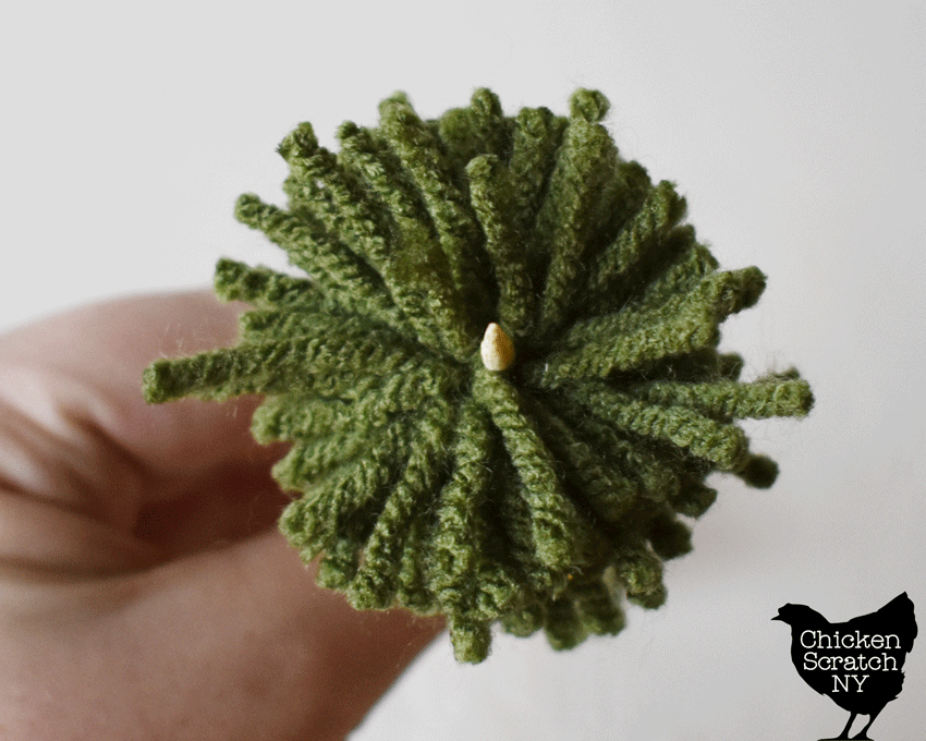 shove wooden skewer through the center of the pompoms