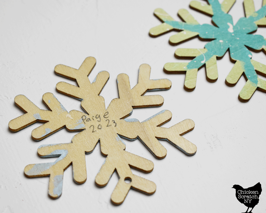 wooden snowflake ornament with 'Paige 2023" handwritten on the back