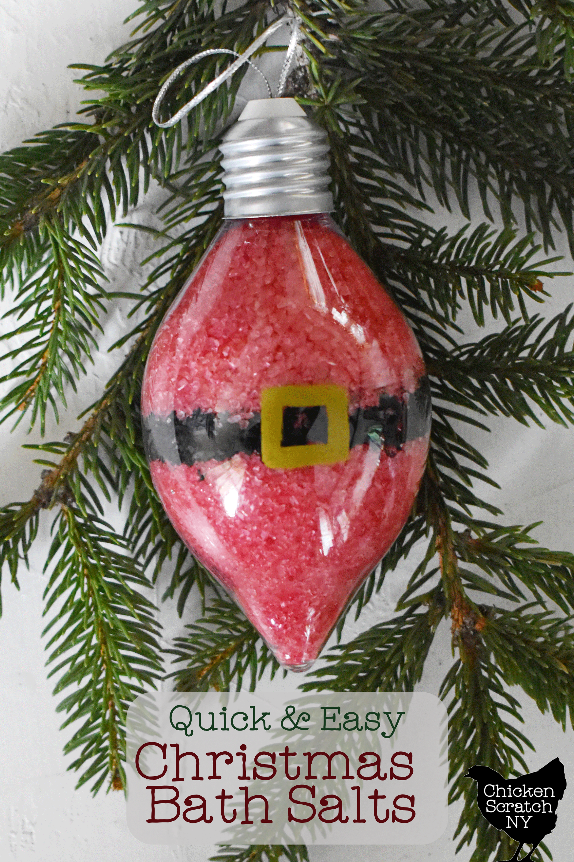 clear plastic ornament filled with red and black bath salts layered to look like Santa