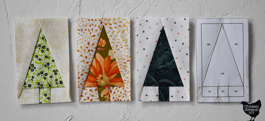 four foundation paper pieced tiny tree blocks, throww showing the front and one showing the back