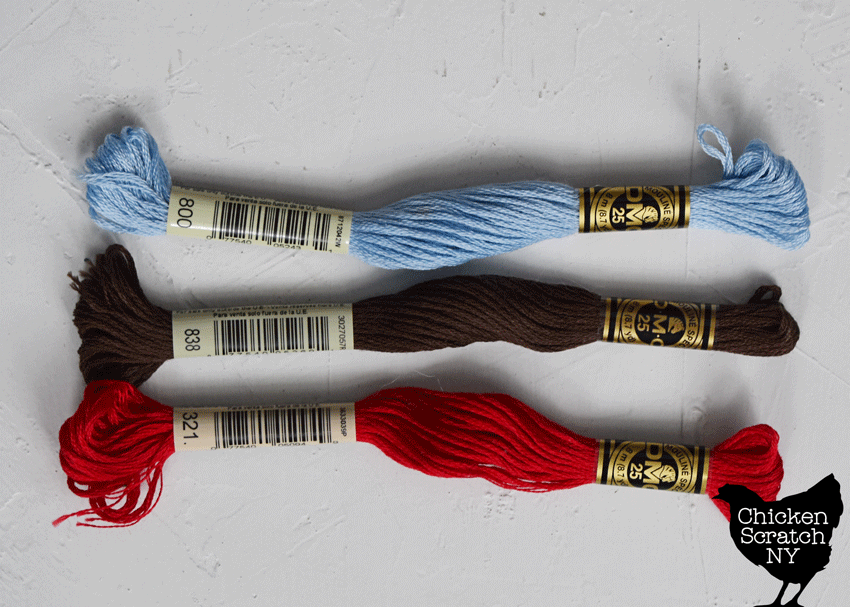 three skeins of 6 strand embroidery floss on a white background