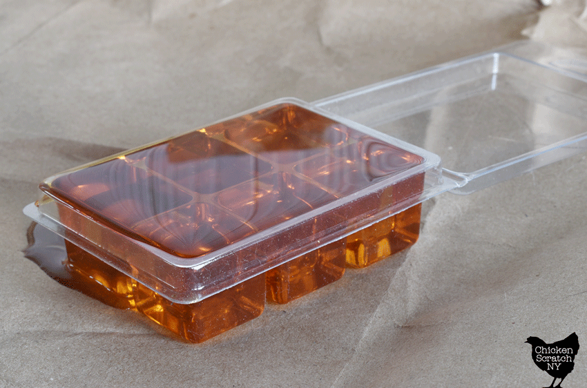 plastic 6 cube clamshell used for wax melts filled with golden colored liquid wax
