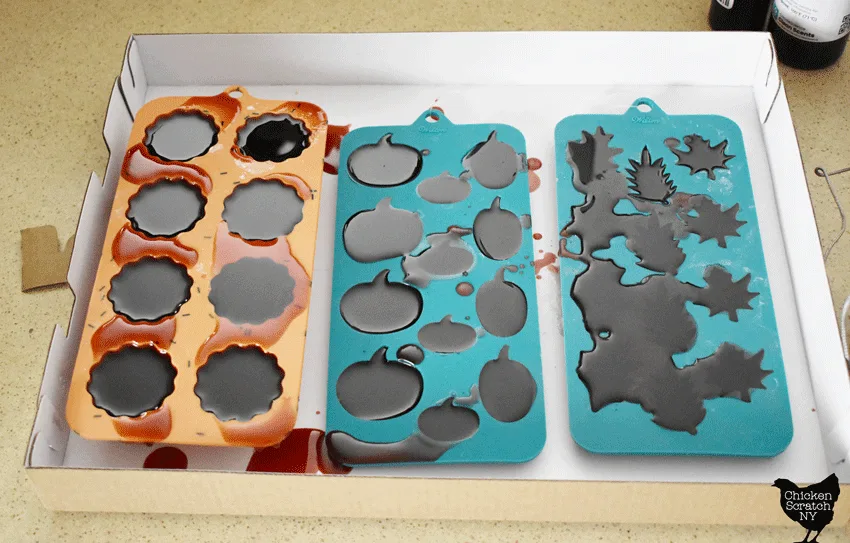 burgundy colored wax poured into three silicone molds